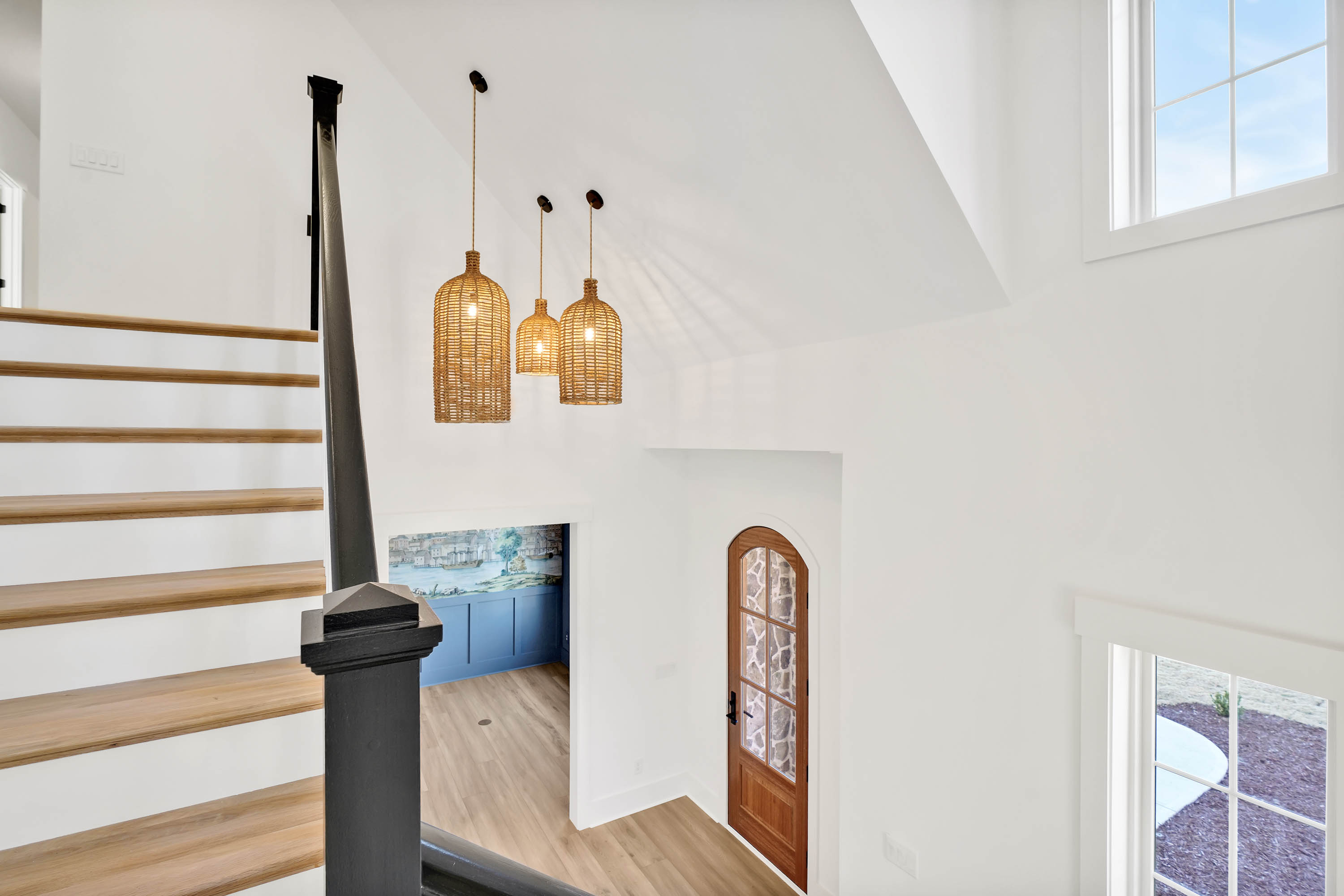 Front foyer room, angle from the stairs looking at the front door