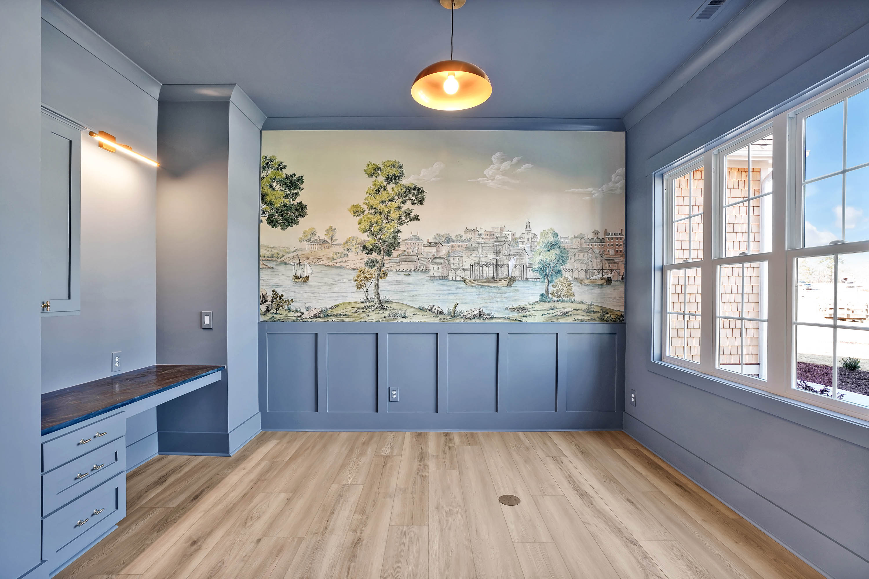 Custom home office space, blue color, mural on wall